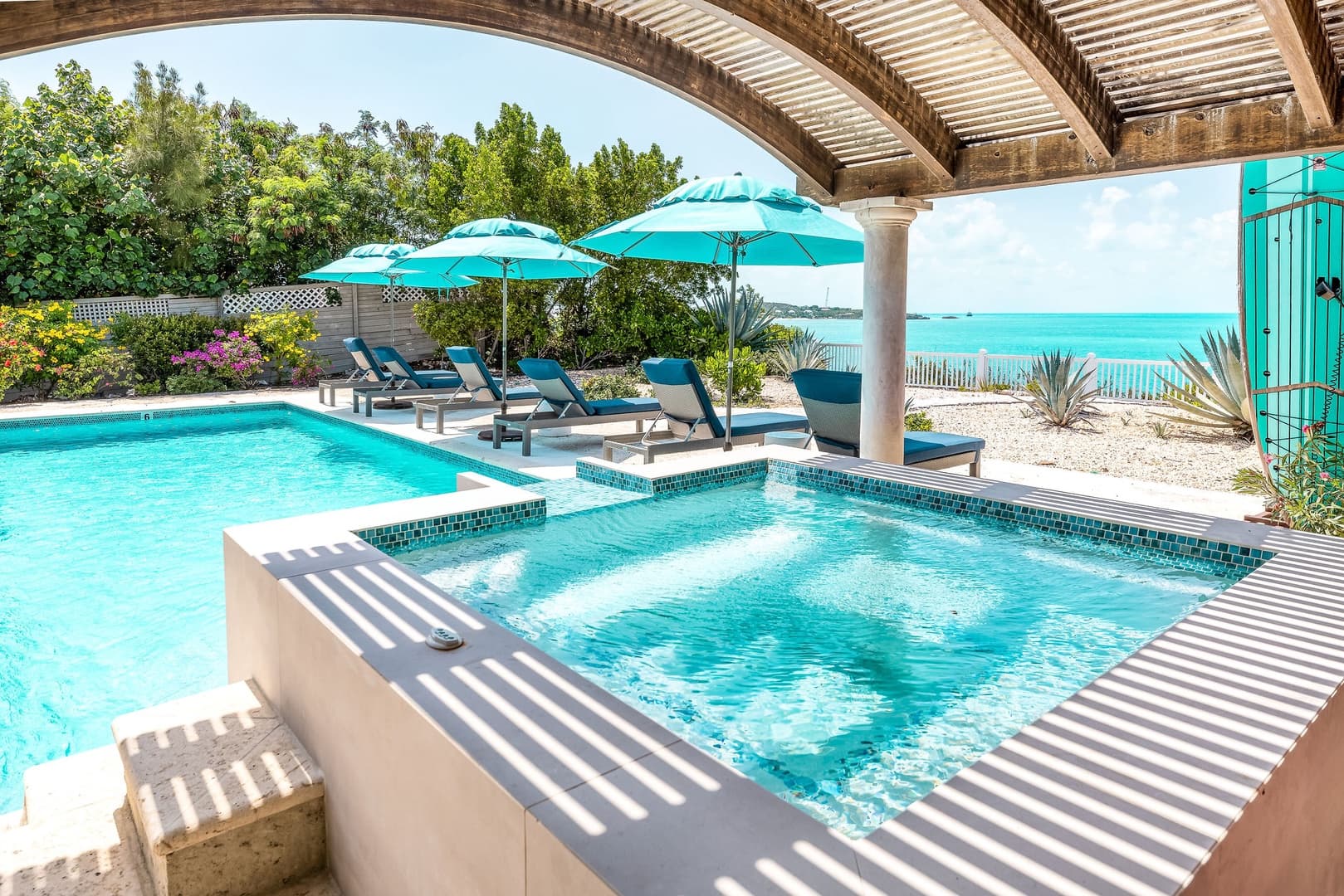 Villa La Percha hot tub and pool with ocean views toward Sapodilla Bay